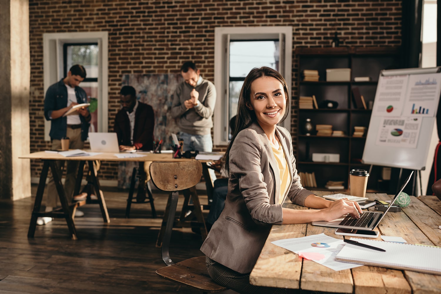 Une femme travaillant sur un ordinateur en souriant